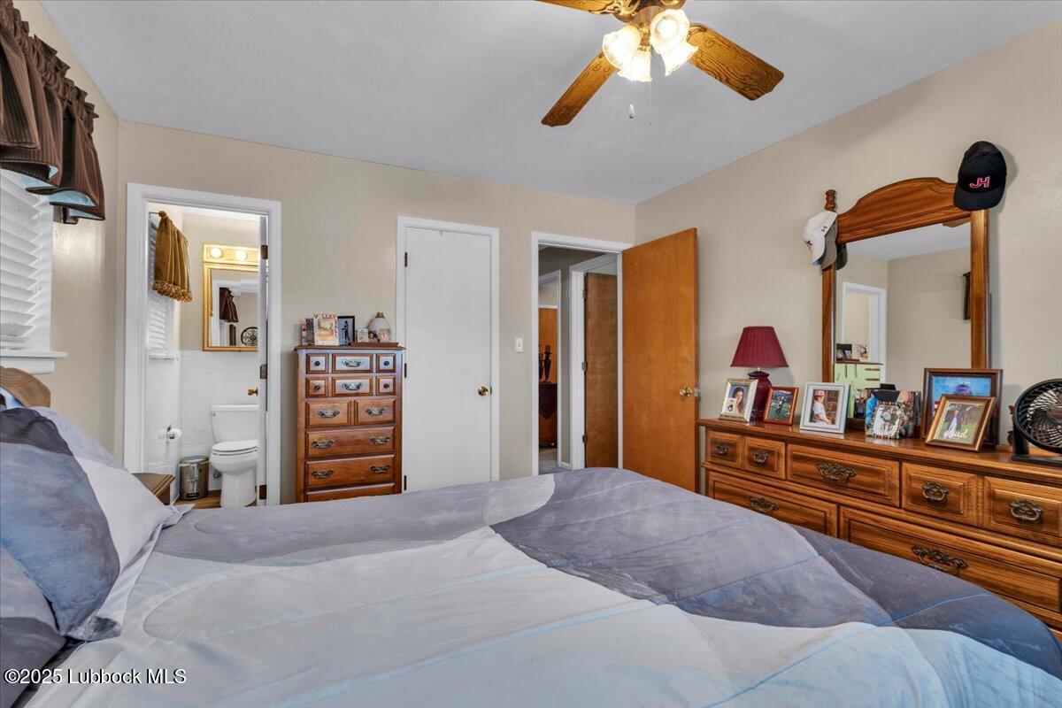 1405 3rd Street Plains, TX 79355 - Photo 4 of 19 a bed room with a bed and dresser