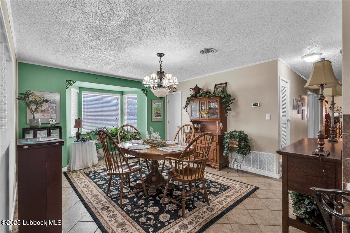 1405 3rd Street Plains, TX 79355 - Photo 5 of 19 a living room with furniture and a chandelier
