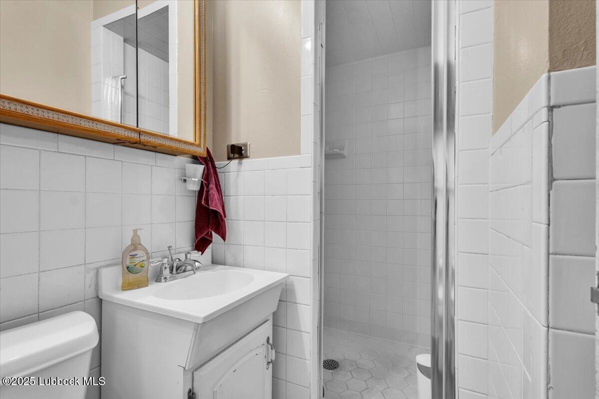 1405 3rd Street Plains, TX 79355 - Photo 8 of 19 a bathroom with a sink toilet and shower