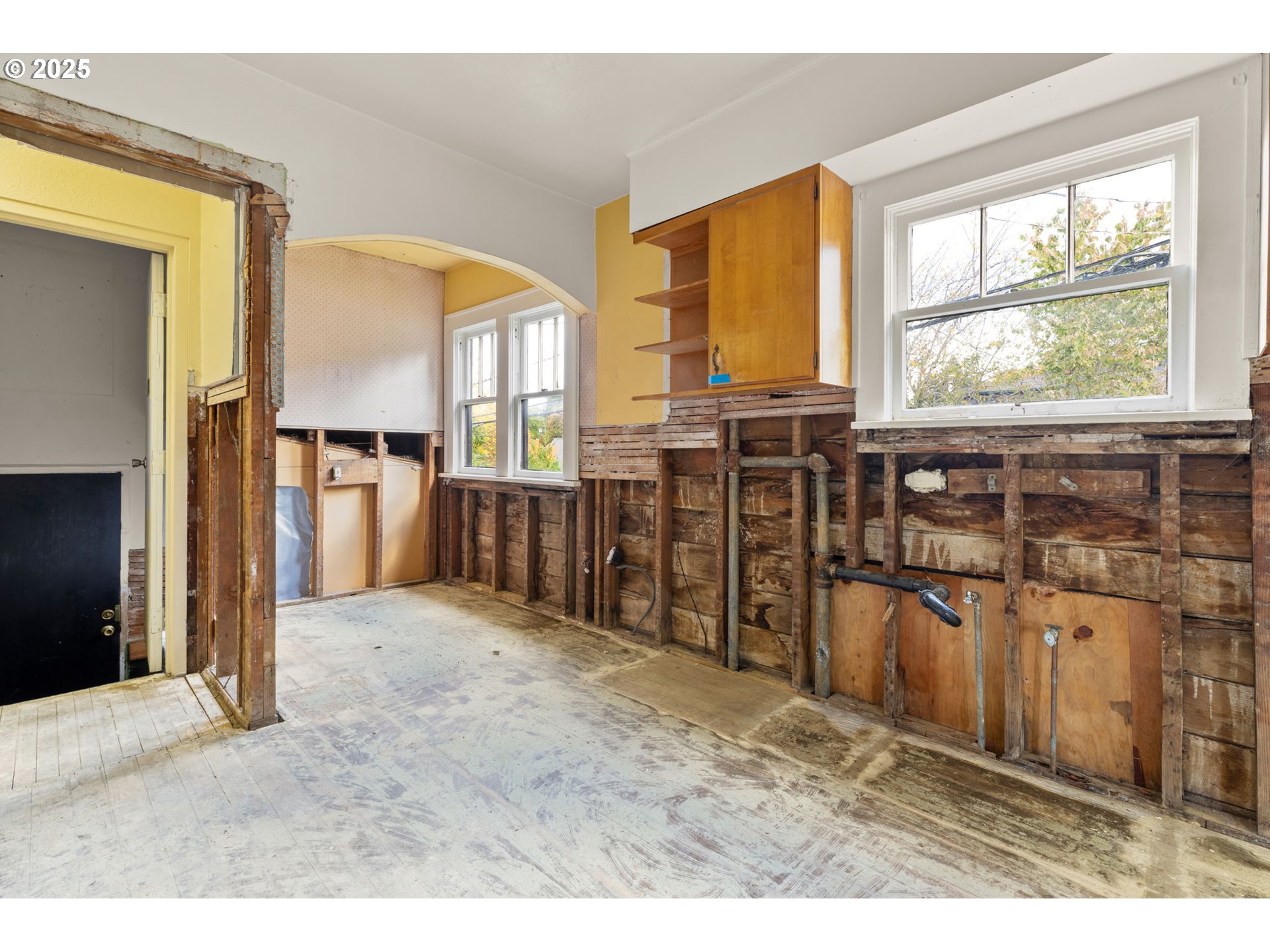 6055 East Burnside Street Portland, OR 97213 - Photo 23 of 32 a view of a kitchen with an entryway and wooden floor