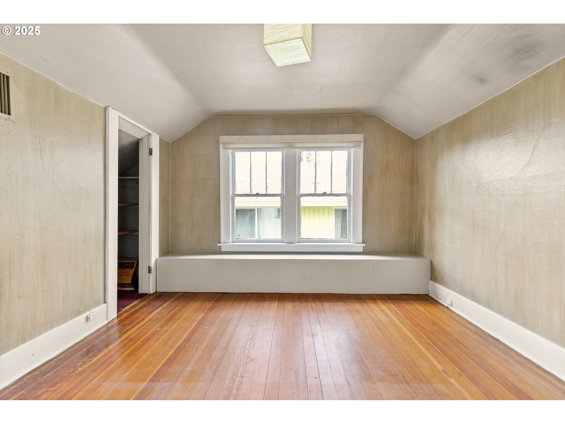 6055 East Burnside Street Portland, OR 97213 - Photo 24 of 32 a view of an empty room with wooden floor and a window