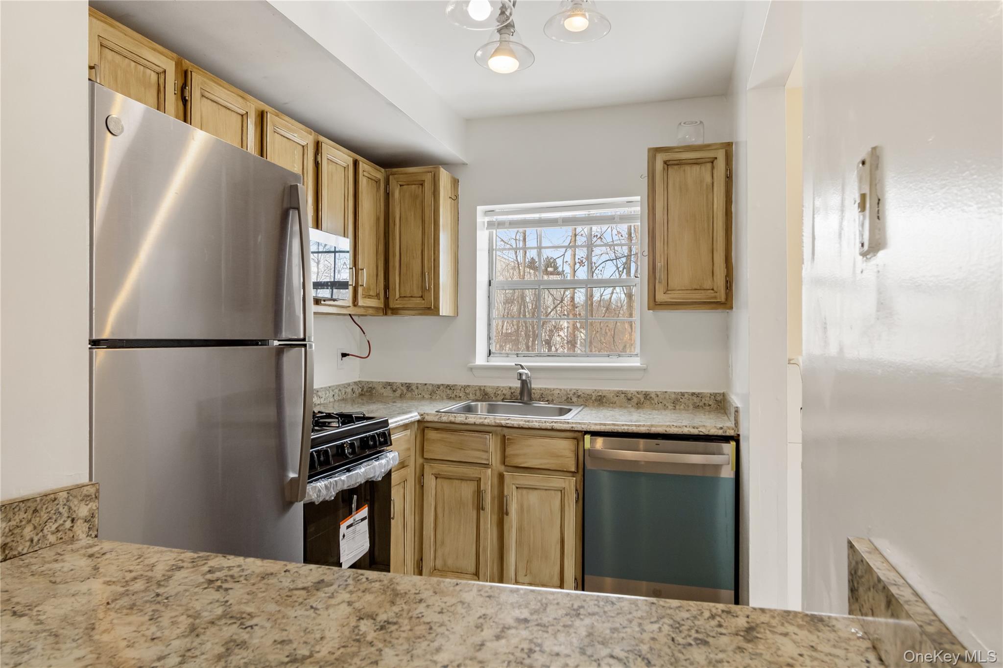 7 Lexington Hills Road, Unit 8 Harriman, NY 10926 - Photo 14 of 17 a kitchen with granite countertop a refrigerator stove top oven and sink