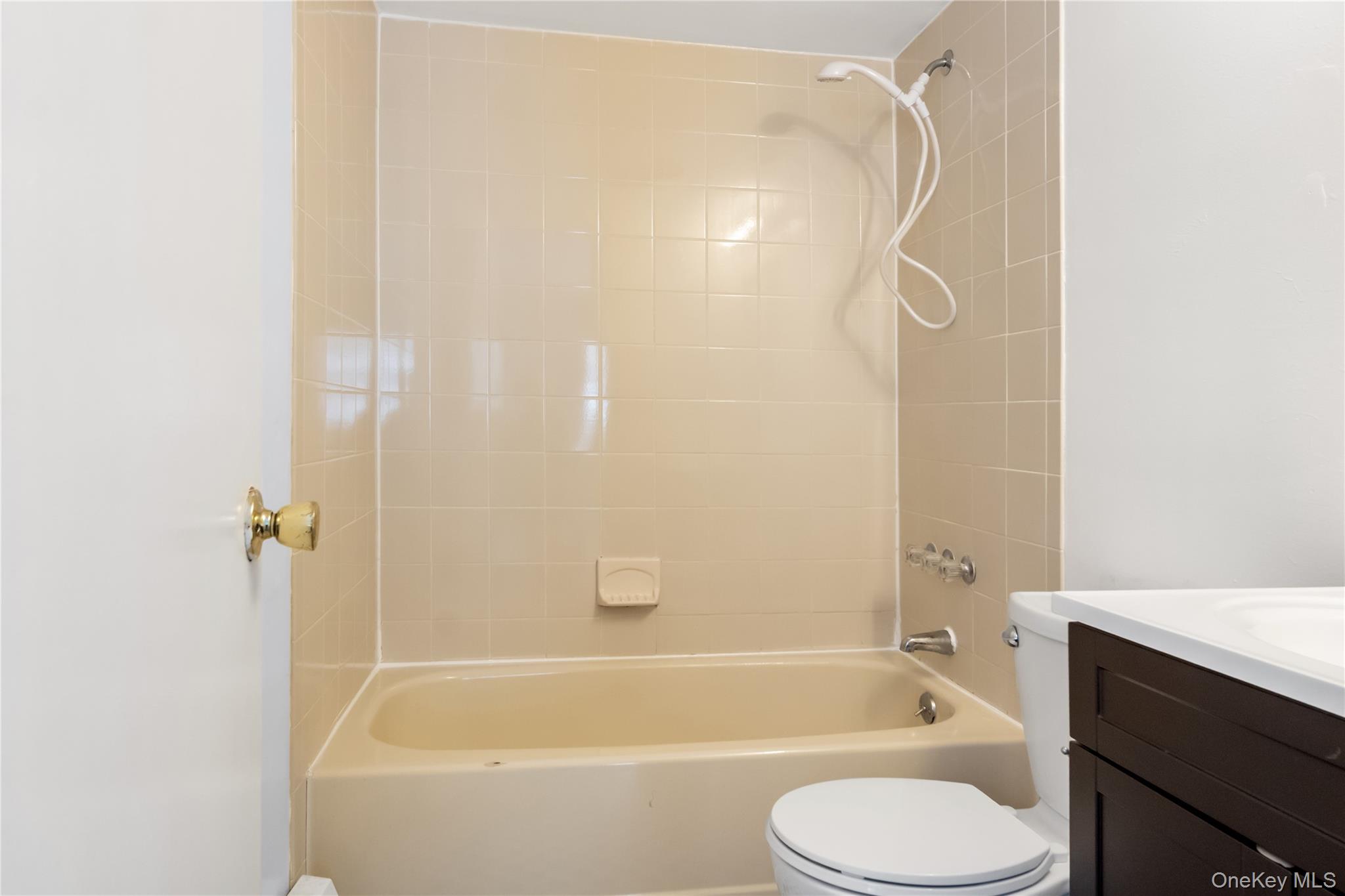 7 Lexington Hills Road, Unit 8 Harriman, NY 10926 - Photo 15 of 17 a bathroom with a shower curtain bathtub and toilet