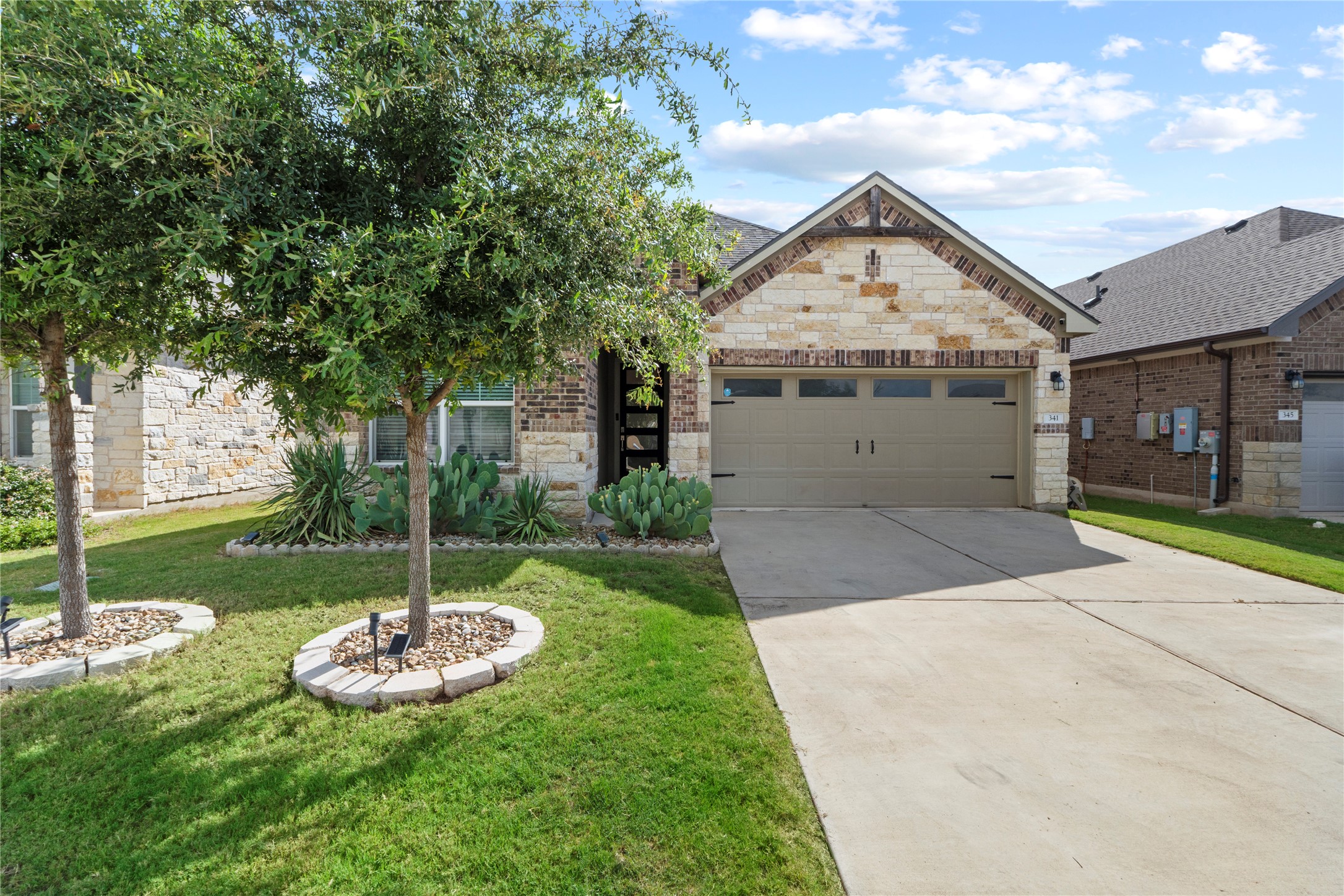 341 Peace Pipe Way Georgetown, TX 78628 - Photo 2 of 28 Large garage door makes it easier to drive in to this garage.