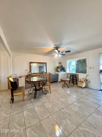 a living room with furniture and a dining table