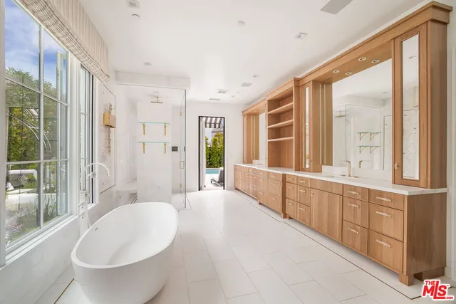 a spacious bathroom with a large tub and shower