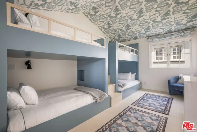 a bedroom with bed and a couch