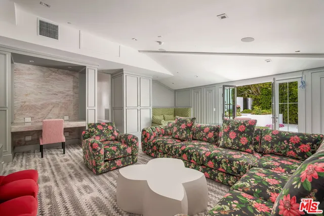 a view of a patio with couches table and chairs and potted plants