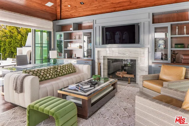a living room with furniture fireplace and flat screen tv