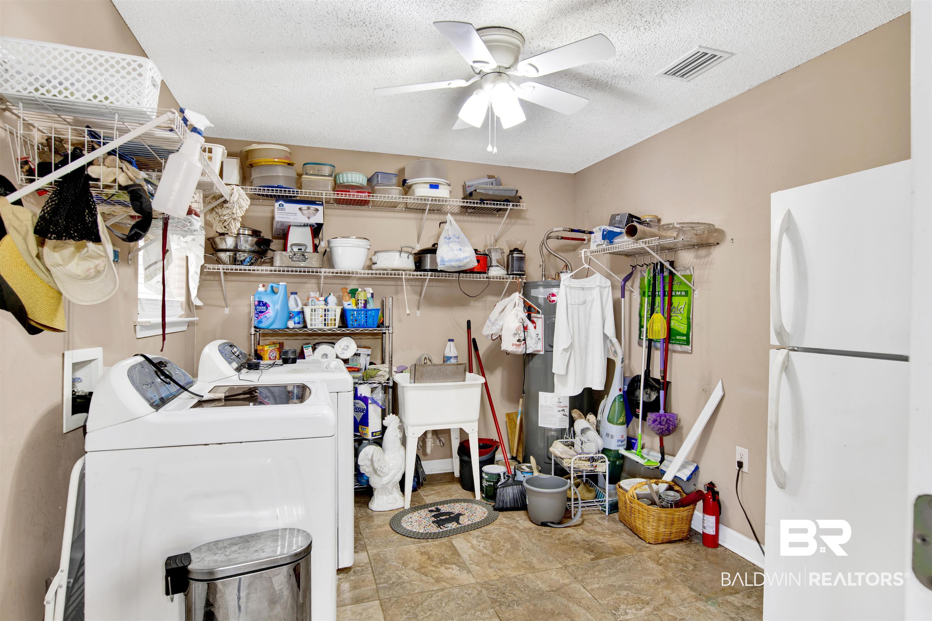 36434 Alexandria Trail Stapleton, AL 36578 - Photo 26 of 27 Washroom with washing machine and clothes dryer, a textured ceiling, and ceiling fan