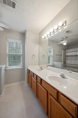 a bathroom with a sink double vanity and a mirror