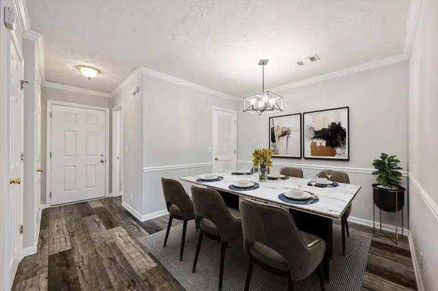 a view of a dining room with furniture and wooden floor