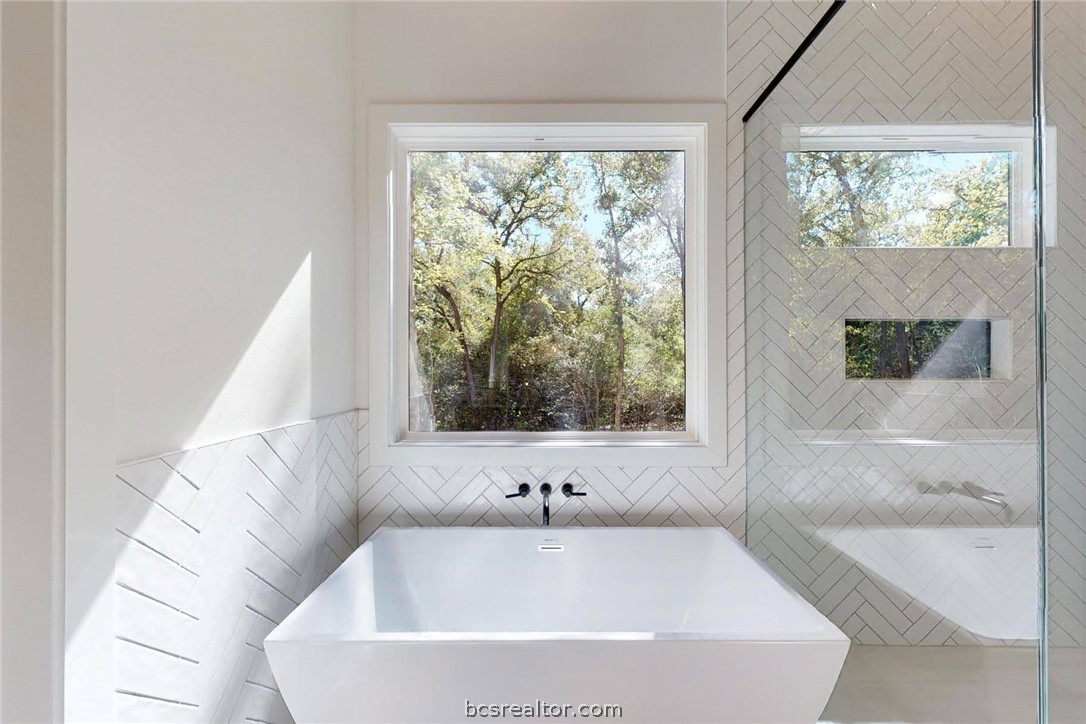 1629 Sawmill Road Franklin, TX 77856 - Photo 24 of 47 a white bath tub sitting in a bathroom next to a window