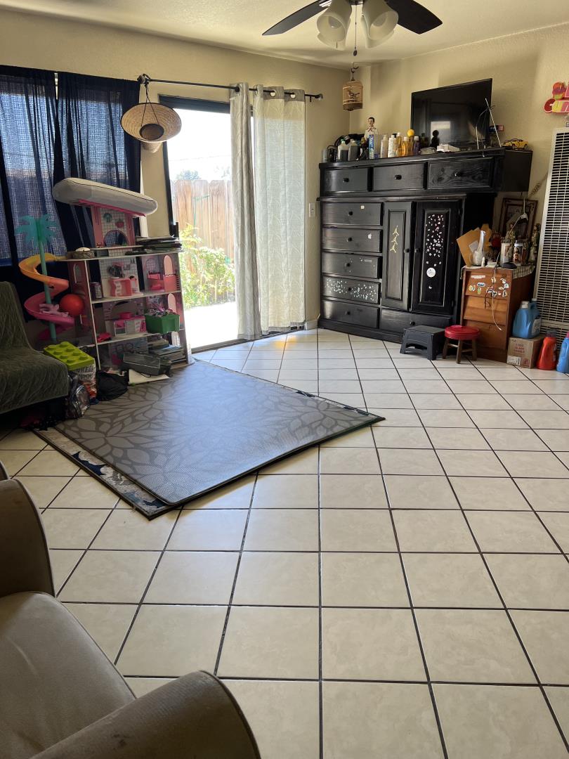 101 Smith Street Salinas, CA 93905 - Photo 14 of 26 a room with gym equipment and a flat screen tv