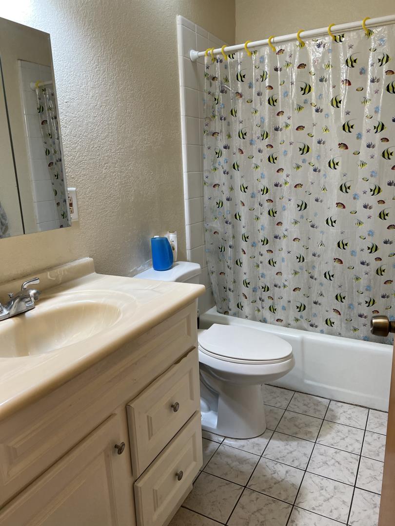 101 Smith Street Salinas, CA 93905 - Photo 24 of 26 a bathroom with a sink a toilet and a mirror