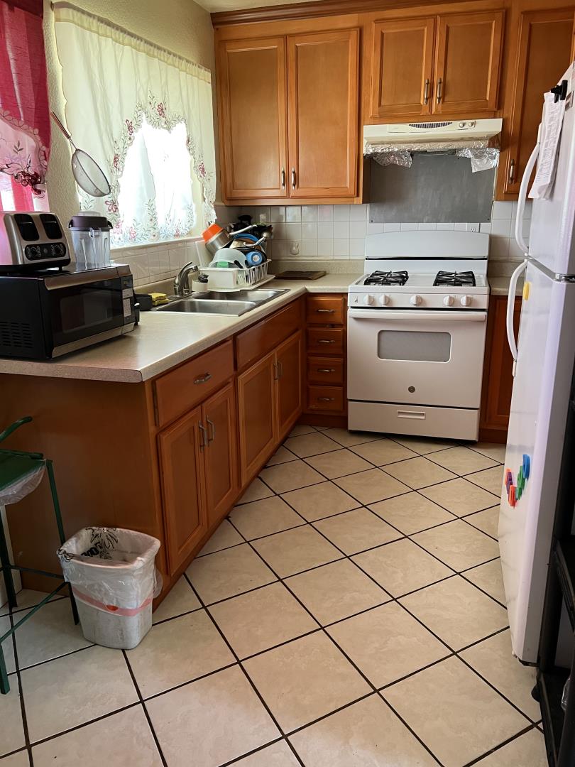 101 Smith Street Salinas, CA 93905 - Photo 8 of 26 a kitchen with a sink stove and cabinets