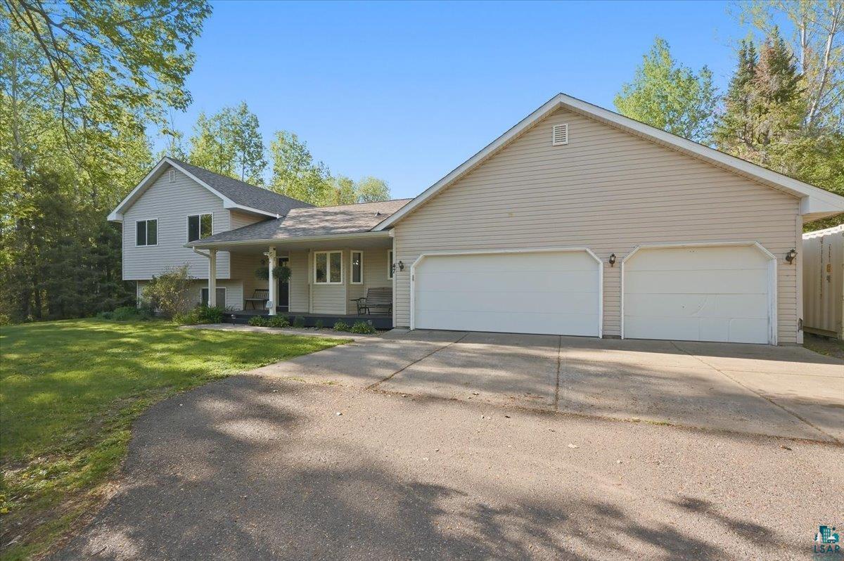 47 Amy Lane Esko, MN 55733 - Photo 27 of 33 Siding exterior with a two-car garage and an extended driveway