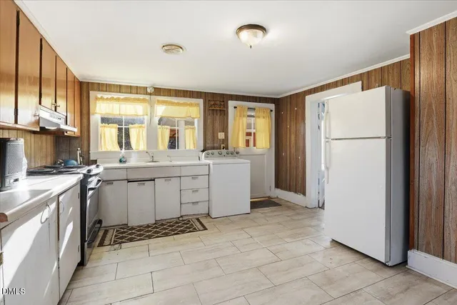 a kitchen with a refrigerator and a sink