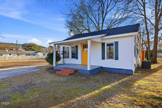 a view of a house with backyard porch and sitting area
