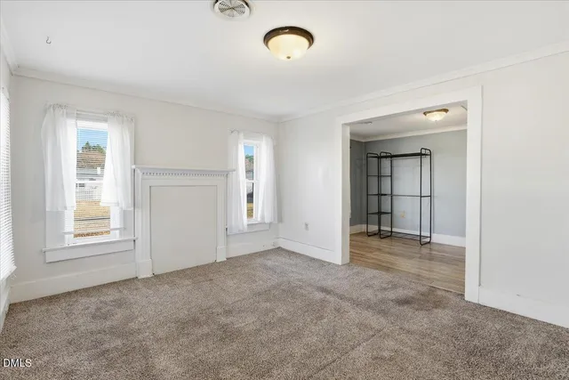 an empty room with windows and entrance