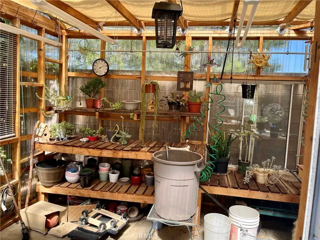 a front view of a house with a potted plant and floor to ceiling window