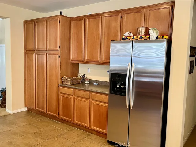 a kitchen with stainless steel appliances granite countertop a refrigerator and a sink
