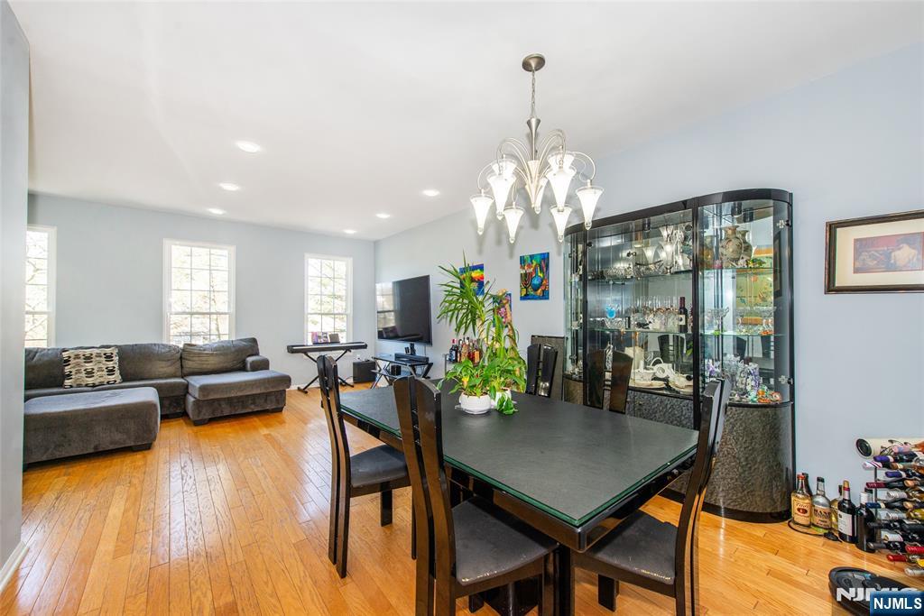 10 Gannet Court Wayne, NJ 07470 - Photo 11 of 24 a view of a dining room and livingroom with furniture wooden floor a chandelier