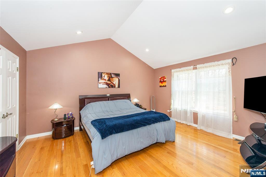 10 Gannet Court Wayne, NJ 07470 - Photo 13 of 24 a bedroom with a bed and a flat tv screen on dresser