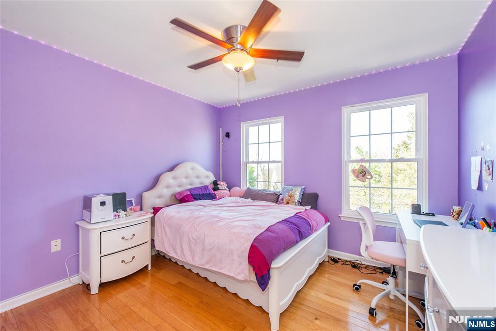10 Gannet Court Wayne, NJ 07470 - Photo 18 of 24 a bedroom with a bed and a chandelier