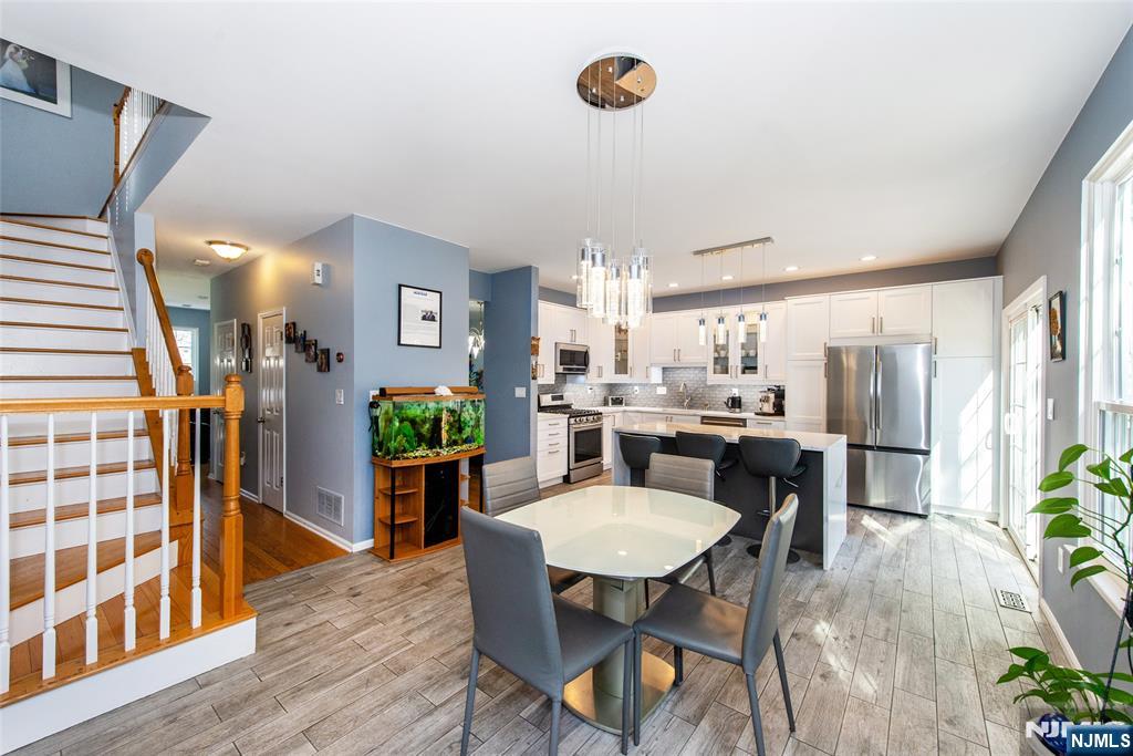 10 Gannet Court Wayne, NJ 07470 - Photo 4 of 24 a kitchen with a table and chairs in it