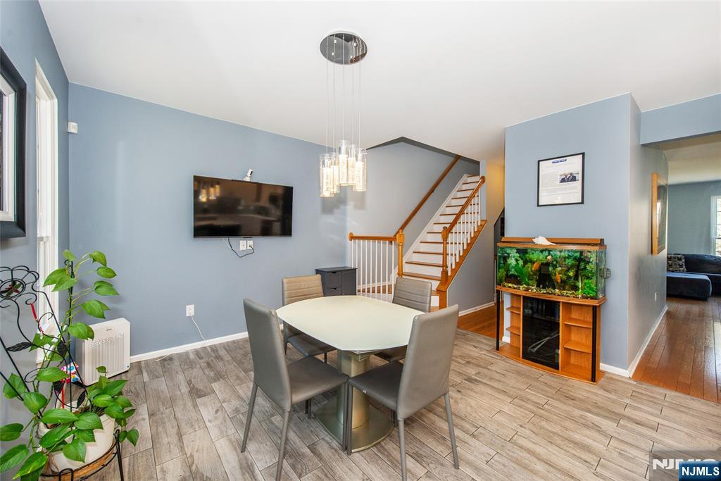 10 Gannet Court Wayne, NJ 07470 - Photo 5 of 24 a view of a livingroom with furniture a flat screen tv and wooden floor