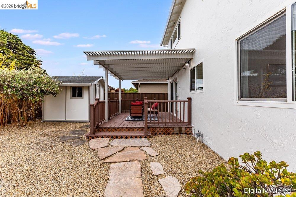 1298 Ribbon Street Foster City, CA 94404 - Photo 79 of 86 Outdoor deck with slatted pergola, featuring wood railing and stone pathway