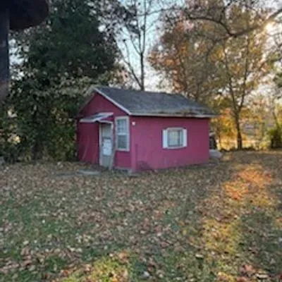 a large house with a tree in the background