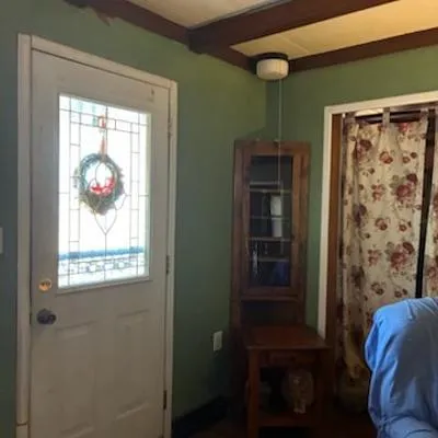 a view of a hallway with wooden floor and a workspace