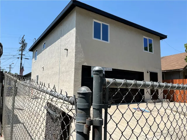 a view of a house with wooden fence