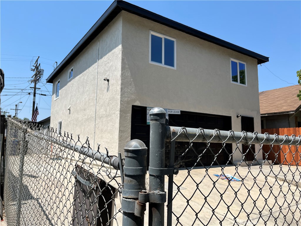 a view of a house with wooden fence