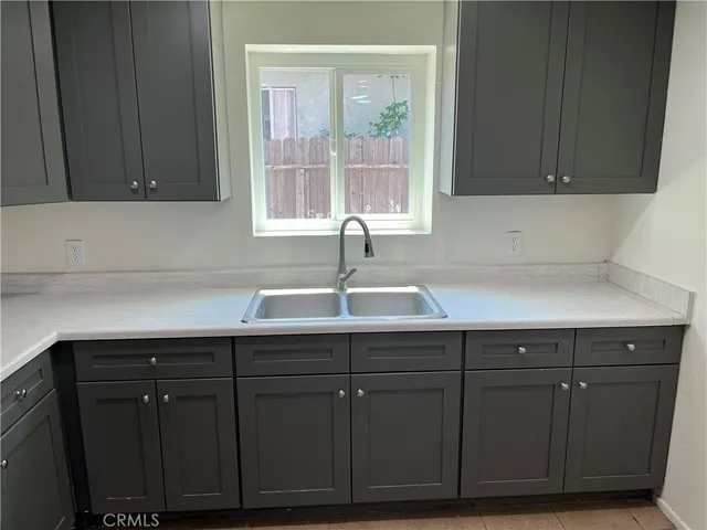 a kitchen with a sink and cabinets