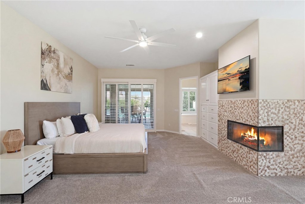 9 Orleans Road Rancho Mirage, CA 92270 - Photo 45 of 71 a spacious bedroom with a bed and a fireplace