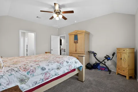 a bed sitting in a bedroom next to a window