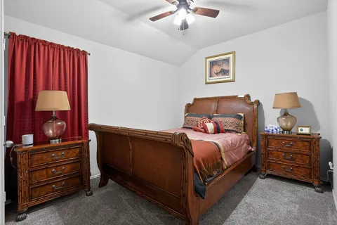 a bedroom with a bed and a large mirror