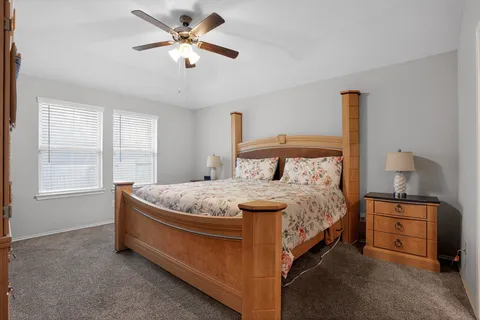a bedroom with a bed and a chandelier