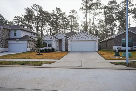 a front view of a house with a yard and trees