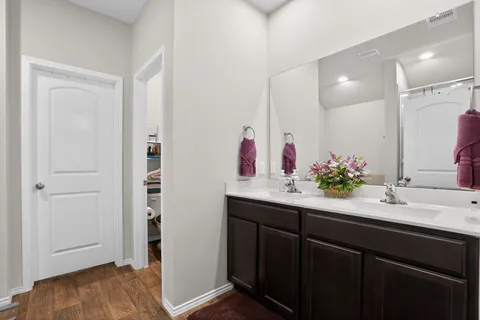 a bathroom with a toilet sink and mirror