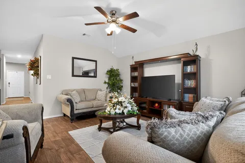 a living room with furniture and a flat screen tv