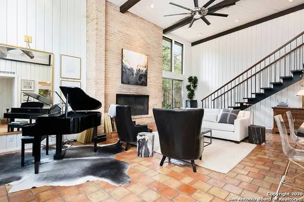 a living room with furniture a fireplace and a chandelier