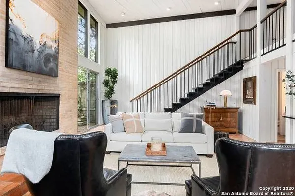 a living room with furniture fireplace and a flat screen tv
