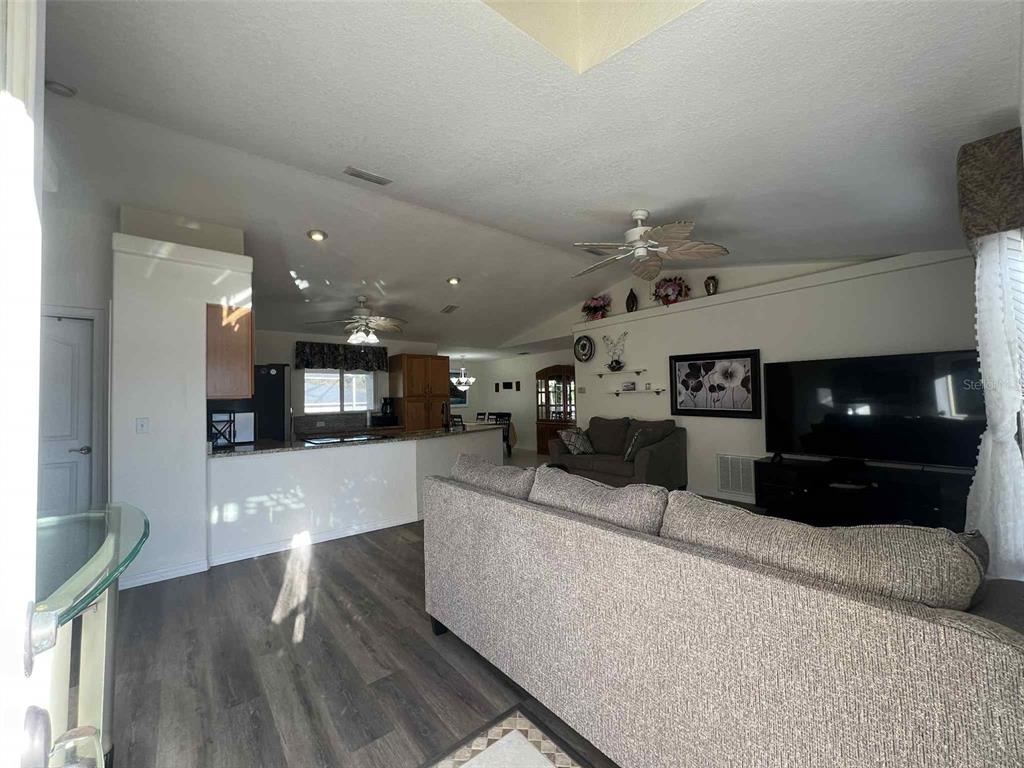 Undisclosed Address Spring Hill, FL 34608 - Photo 3 of 10 a living room with furniture and a flat screen tv