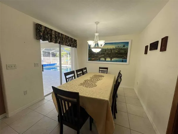 a view of a dining room with furniture and chandelier