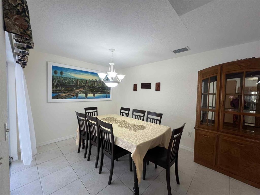 Undisclosed Address Spring Hill, FL 34608 - Photo 6 of 10 a view of a dining room with furniture and wooden floor
