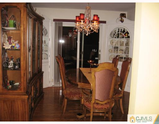 399 Plainfield Road Edison, NJ 08820 - Photo 2 of 8 a view of a dining room with furniture and a chandelier